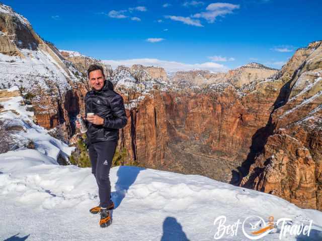 A hiker in the snow with crampons on the summit.