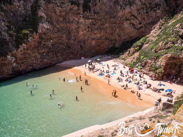 The beach full of visitors and many swimmers