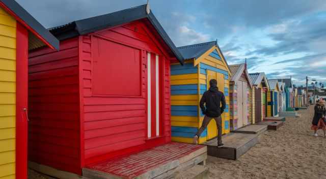 A man is walking from Beach Box to Beach Box