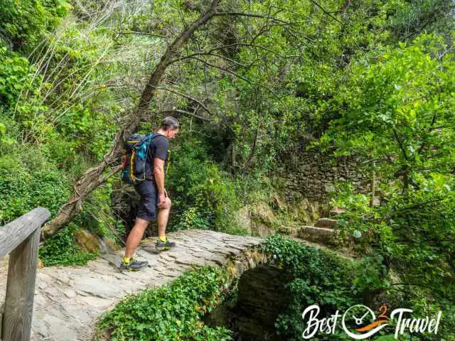 A hiker on the coastal trail along the terraces.