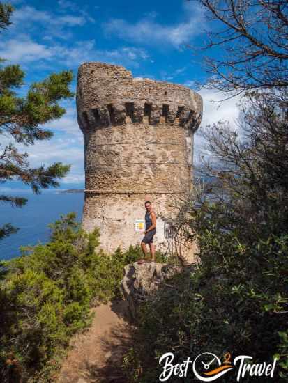 A hiker in front of the Capo di Muro Tower