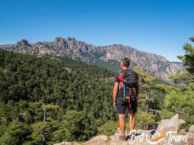 A hiker looking to the peaks of Col de Bavella