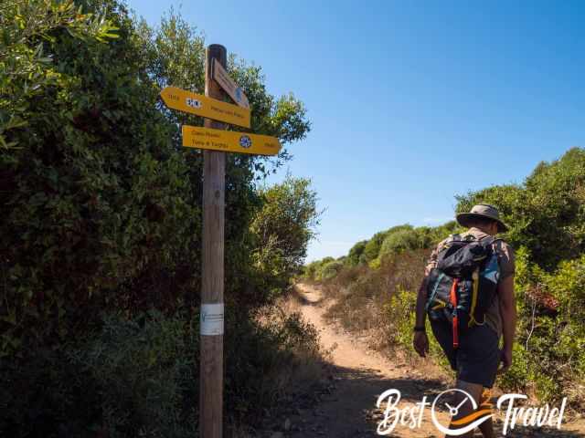 A hiker at the junction where the path branches off.