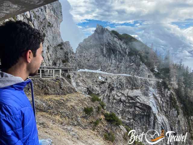 A visitor admiring the view to the mountains and the path.