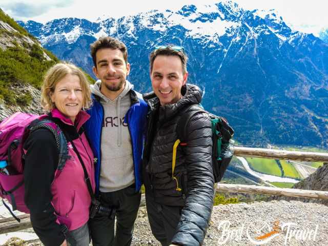 Three visitors with the mountain range in the back.