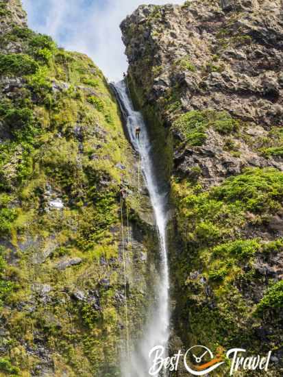 A canyoneering group in the waterfall.