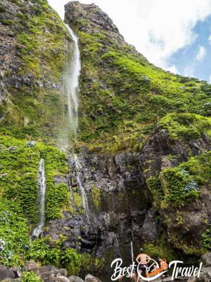 Visitors having a bath at the bottom of the waterfall.