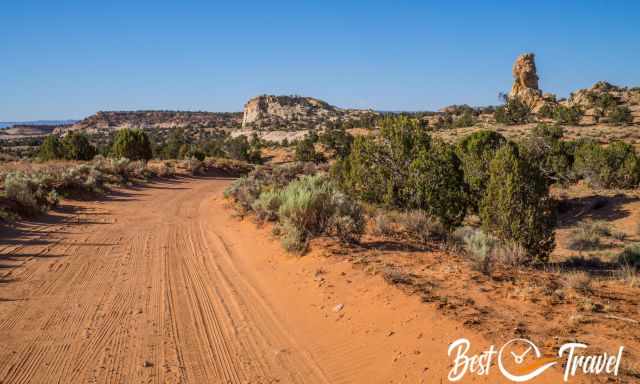 The Spencer Flat Road leads through red sand.