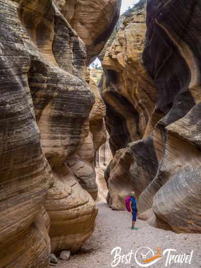 A hiker looks tiny in this huge and narrow canyon of Willis Crrek.