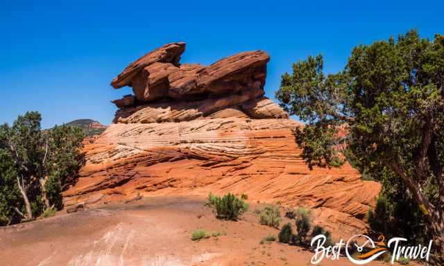 An orange and brown sandstone rock formation hoodoo like