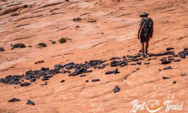 Black hard stones on slick rock