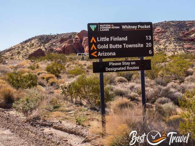 Road sign wit mileage for Little Finland and the Ghost Town