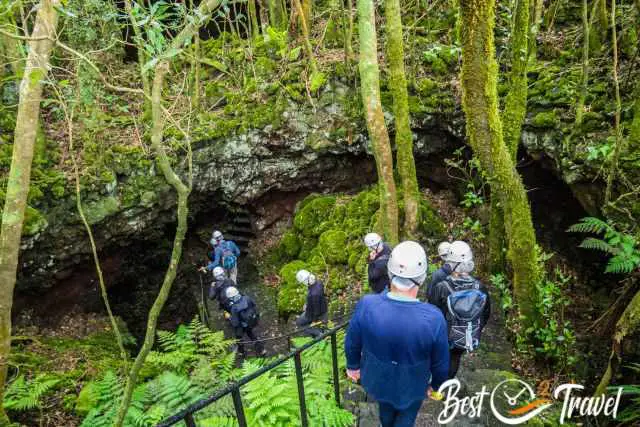 Visitors with helmet on the stairs down into the cave