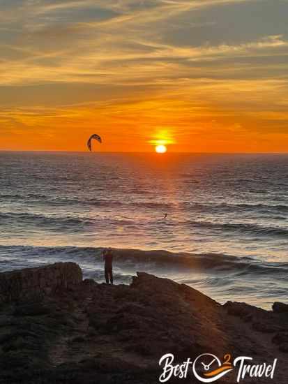 A kite surfer at sunset