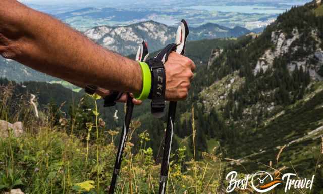 A hiker in the mountains with his leki hiking poles.