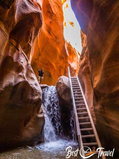 A hiker at the top of the first waterfall