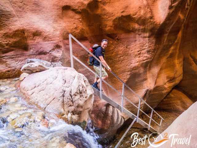 A hiker on the ladder at the first waterfall