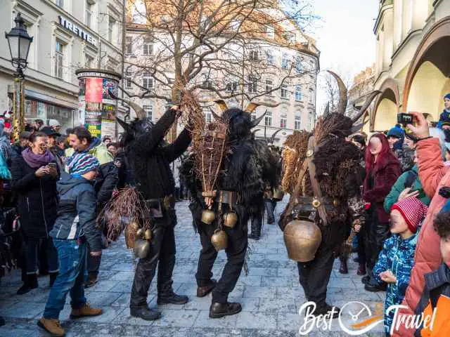 Three Krampus with heavy bells at the belt.