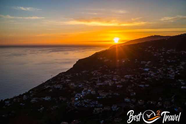 A sunset at higher elevation with a view to a village in the south