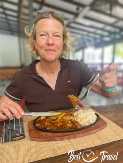 A woman having rice and fresh fish for lunch.