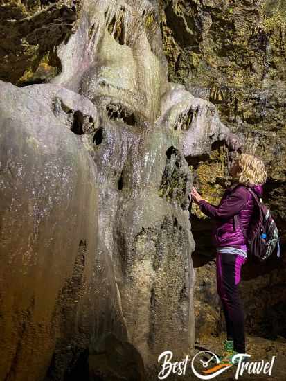 A female hiker at one of the cave formations