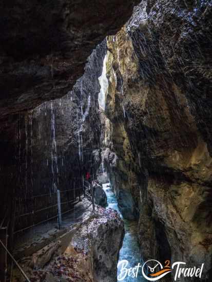 Dripping water and orange leaves in autumn at the walls of the gorge