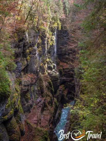 Sunlight is shimmering in the spray of the waterfall.