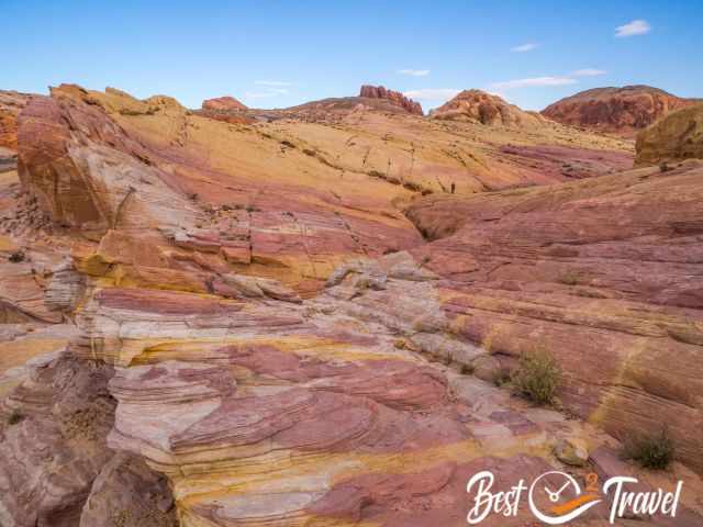 A hiker on the edge of the pastel canyon