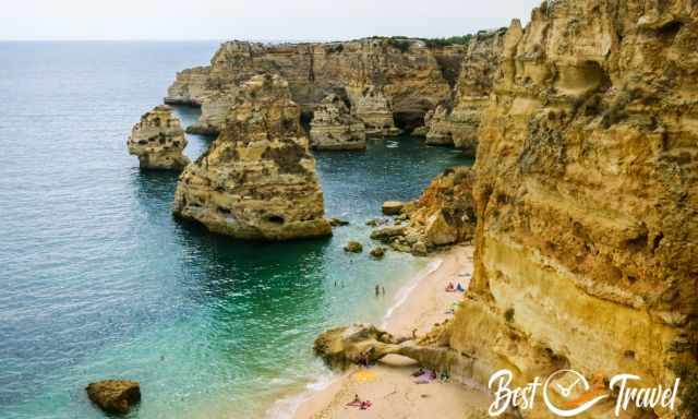 Praia da Marinha with sun bathers in summer