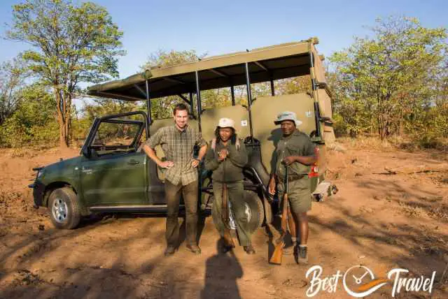 Two armed rangers with us in front of the tour jeep