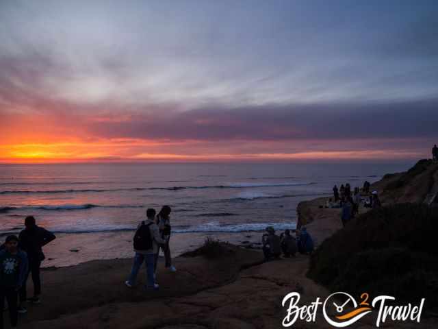 Visitors on the cliff top admiring the sunset