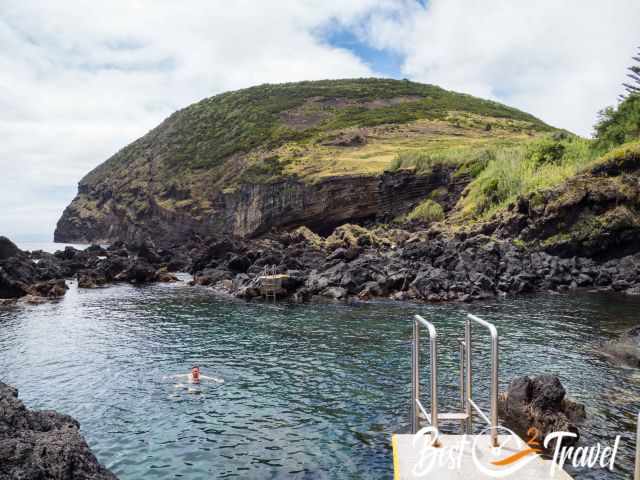 A man in a natural swimming pool.