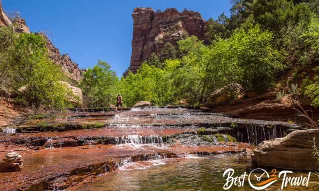 A woman walking up on orange reddish cascades