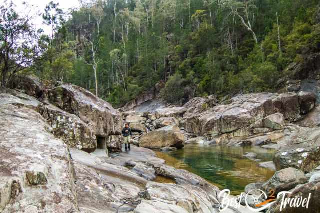 A hiker next to a waterhole in the gorge