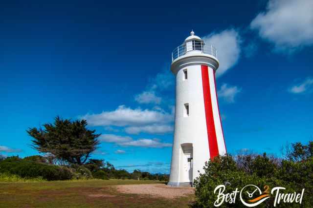 The white and red striped Mersey Bluff Lighthouse with a blue sky.