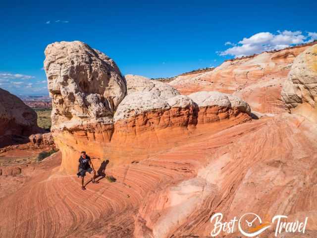 A hiker at red, orange and white formations