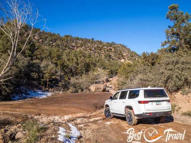 A 4 WD crossing a dry creek