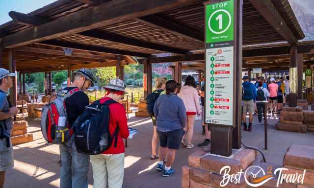 Visitors line-up at the bus station at the visitor centre 